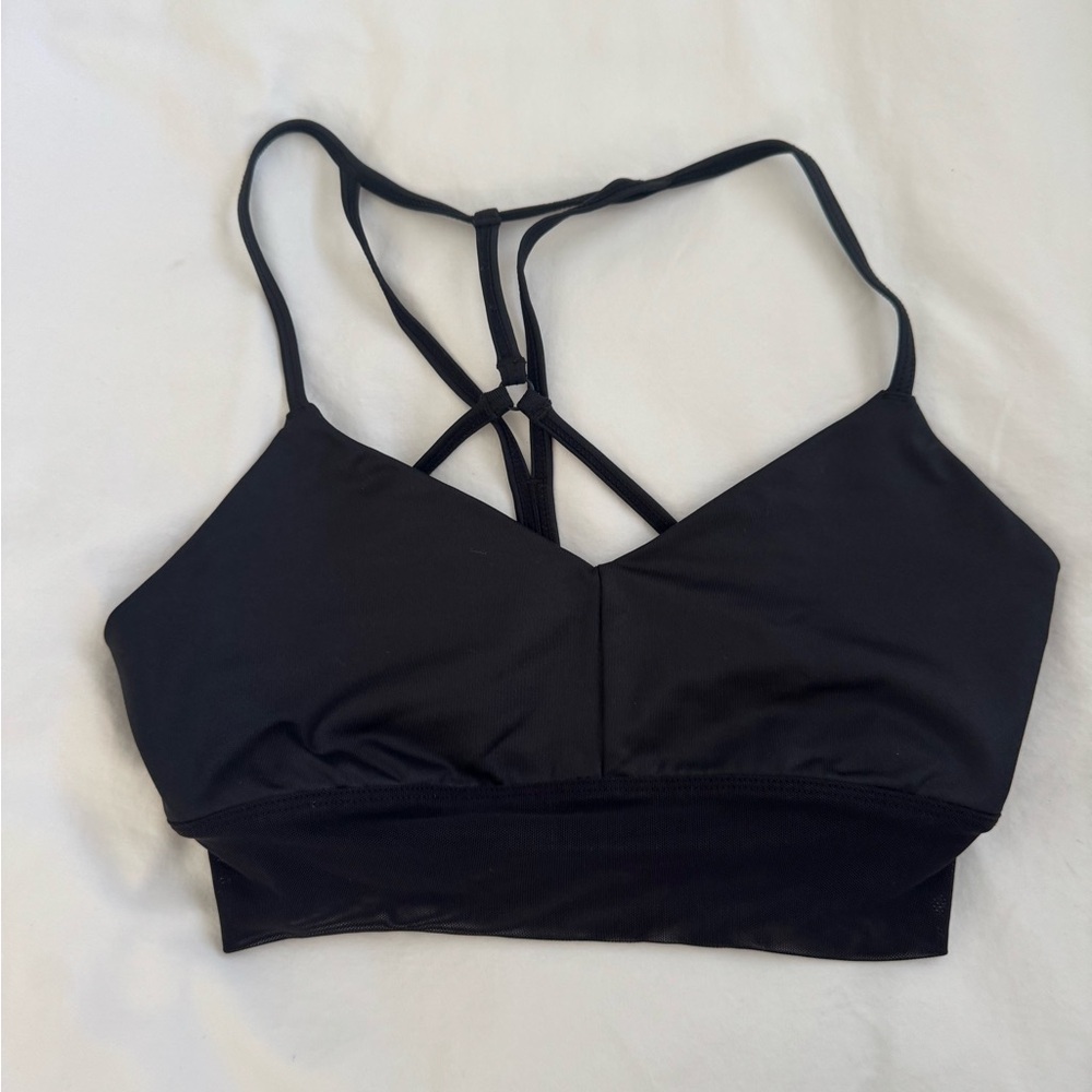 Alo Yogs Black Strappy sports bra with the mesh detail